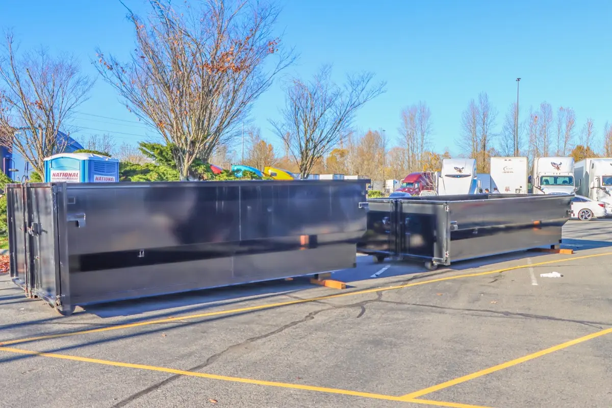 Professional dumpster rental service with roll-off container on residential driveway in Angleton